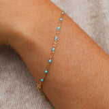14k Gold Turquoise Beaded Bracelet on a wrist, showcasing ocean-inspired color and adjustable length.