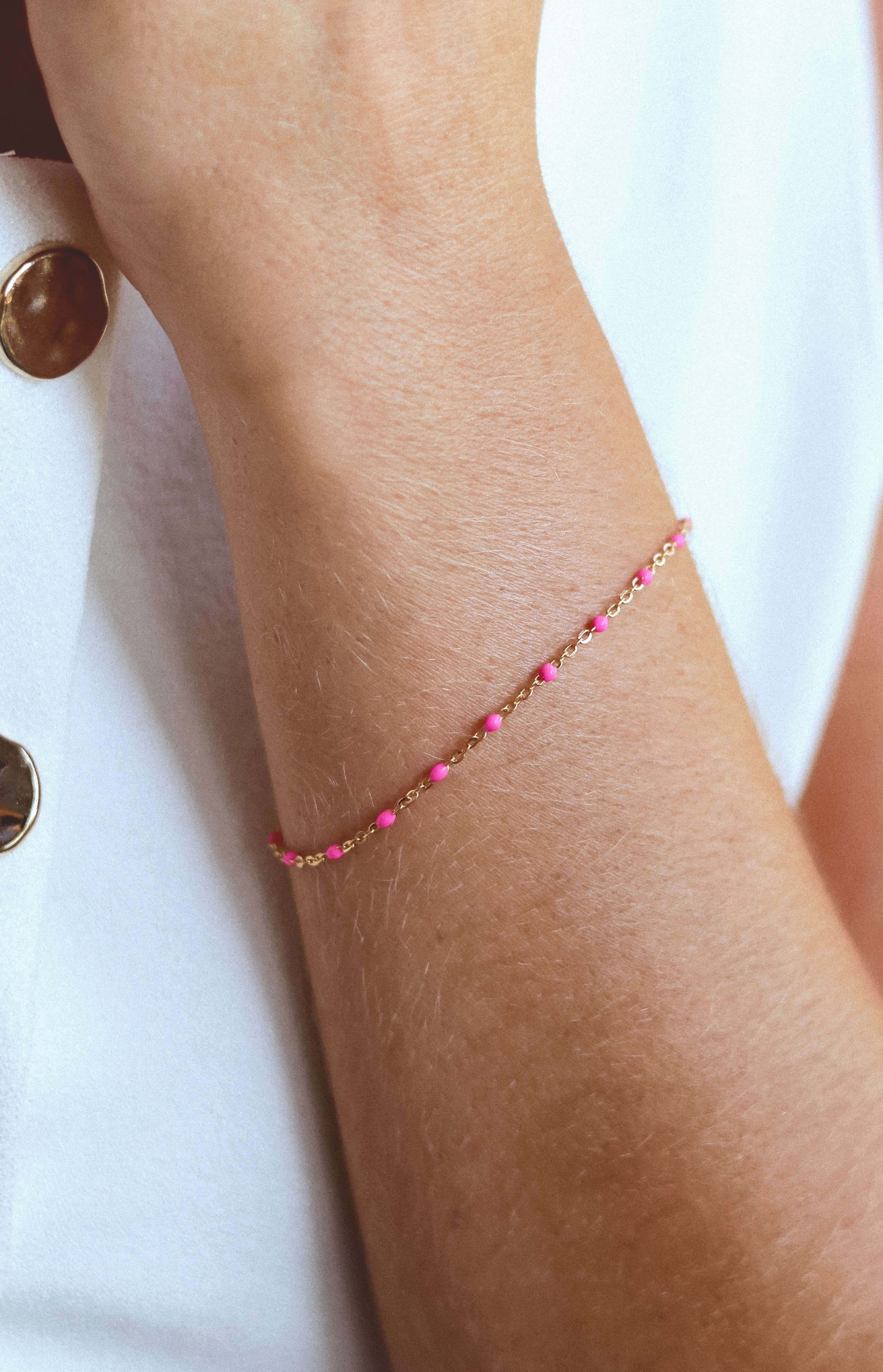14k Gold-Filled Pink Beaded Bracelet on a wrist, showcasing blush pink beads on a delicate gold chain for a feminine touch.