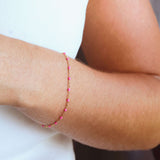 14k gold-filled pink beaded bracelet worn on a woman's wrist, showcasing feminine elegance and vibrant color.