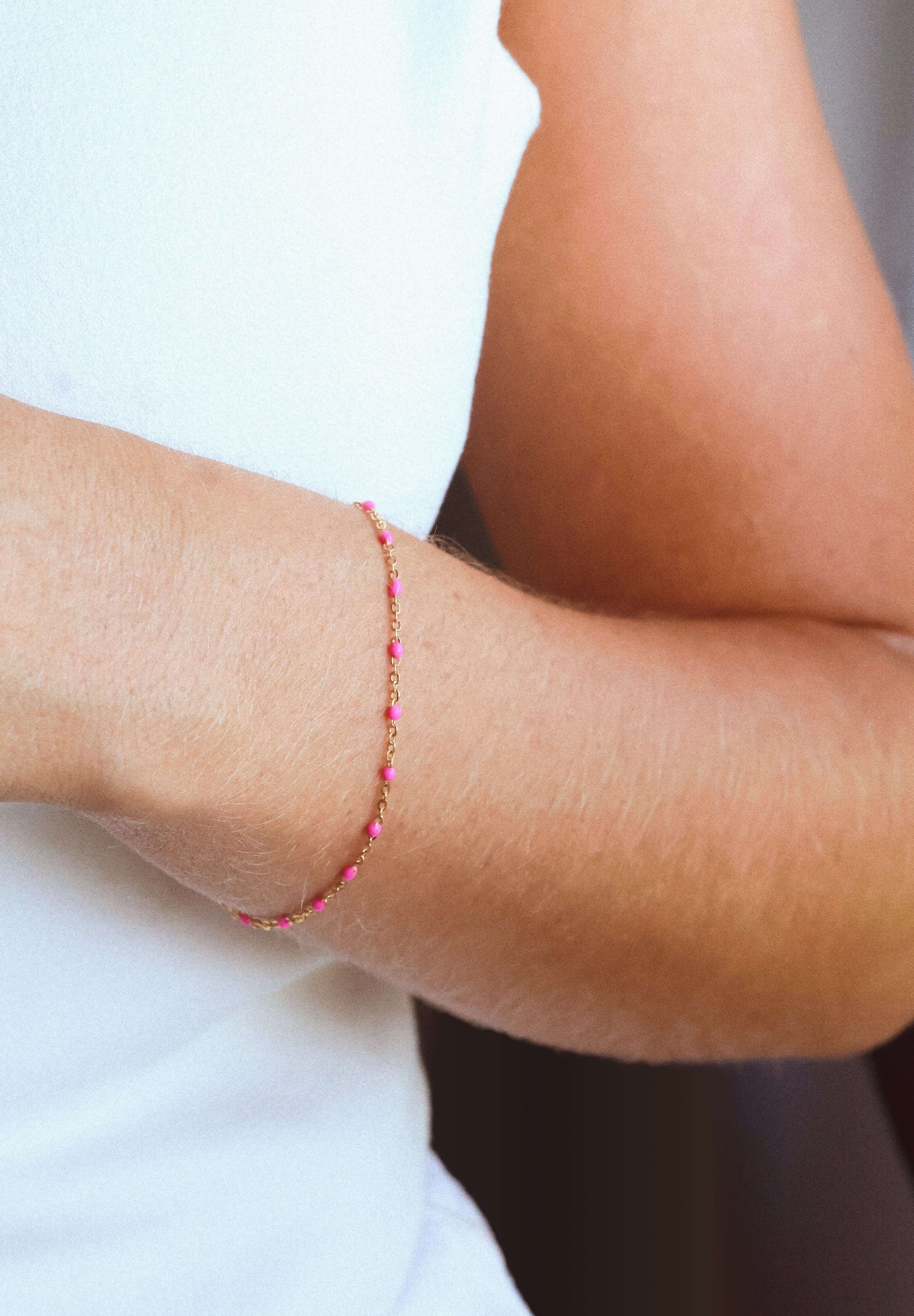14k gold-filled pink beaded bracelet worn on a woman's wrist, showcasing feminine elegance and vibrant color.