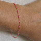 14k gold-filled pink beaded bracelet on wrist, showcasing soft feminine glow and adjustable sizing for everyday wear.