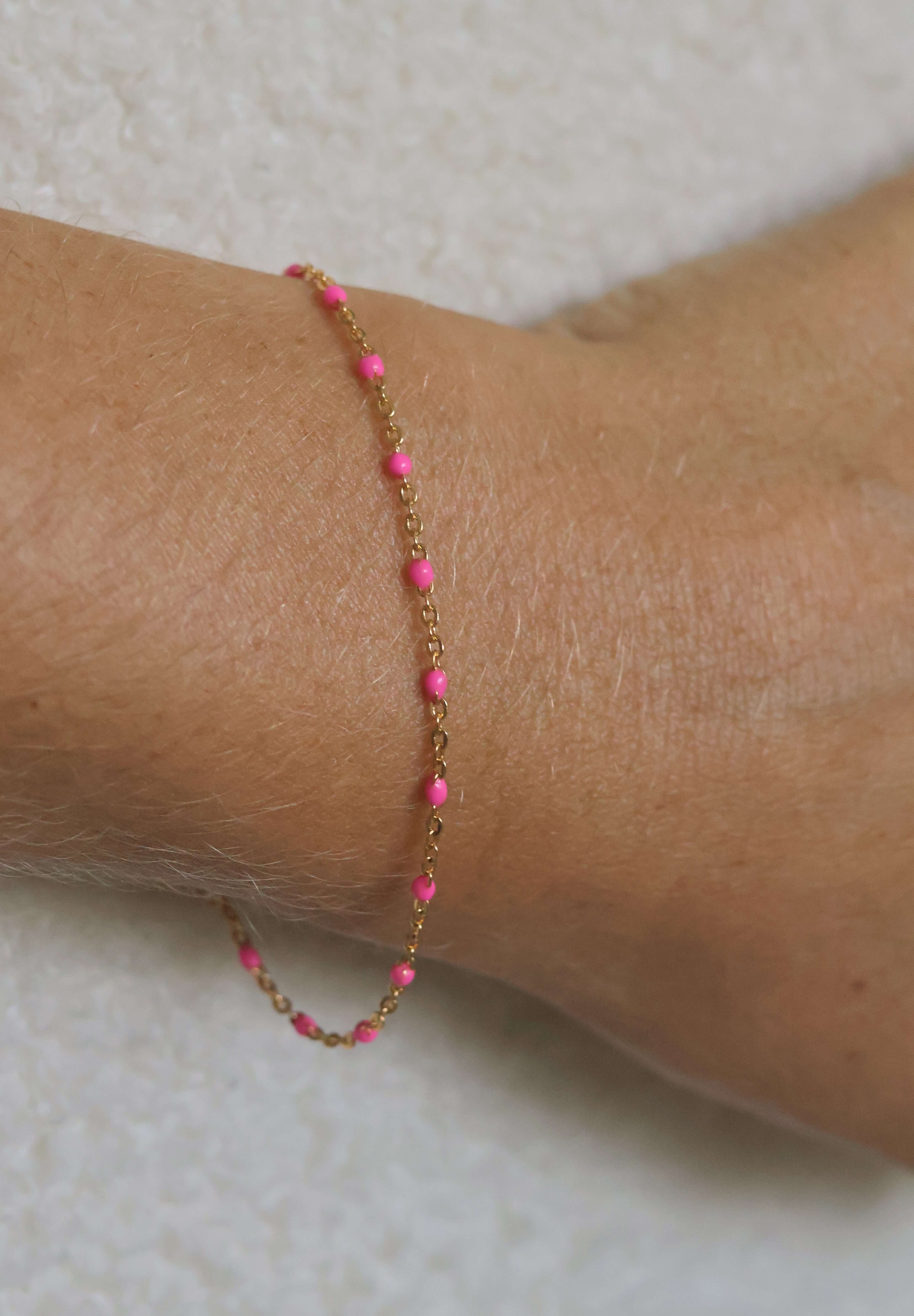 14k gold-filled pink beaded bracelet on wrist, showcasing soft feminine glow and adjustable sizing for everyday wear.