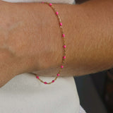14k gold-filled pink beaded bracelet worn on wrist, showcasing soft feminine glow and elegant design.