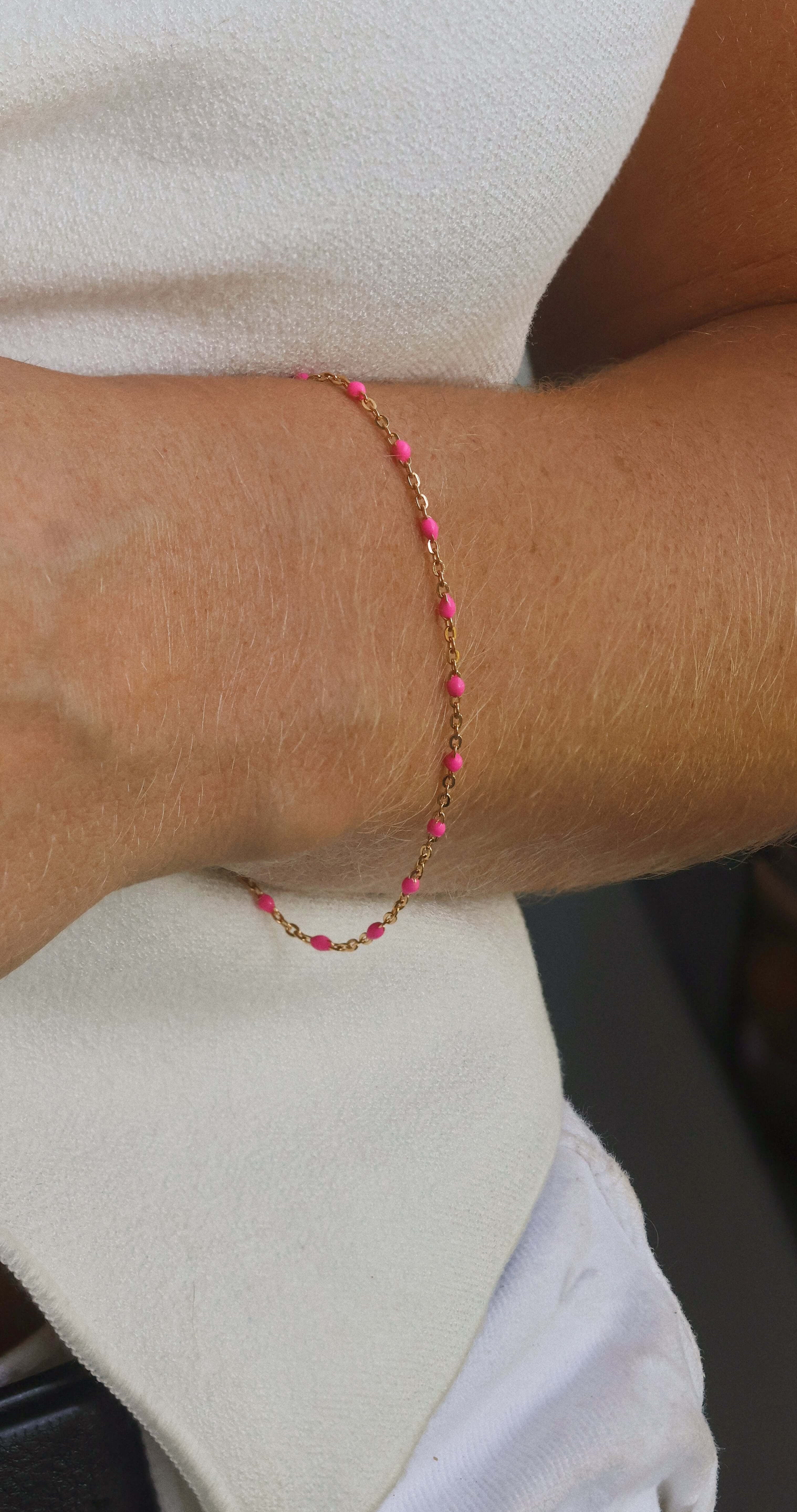 14k gold-filled pink beaded bracelet worn on wrist, showcasing soft feminine glow and elegant design.