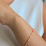 14k gold-filled pink beaded bracelet worn on a woman's wrist, showcasing blush pink details and elegant design.