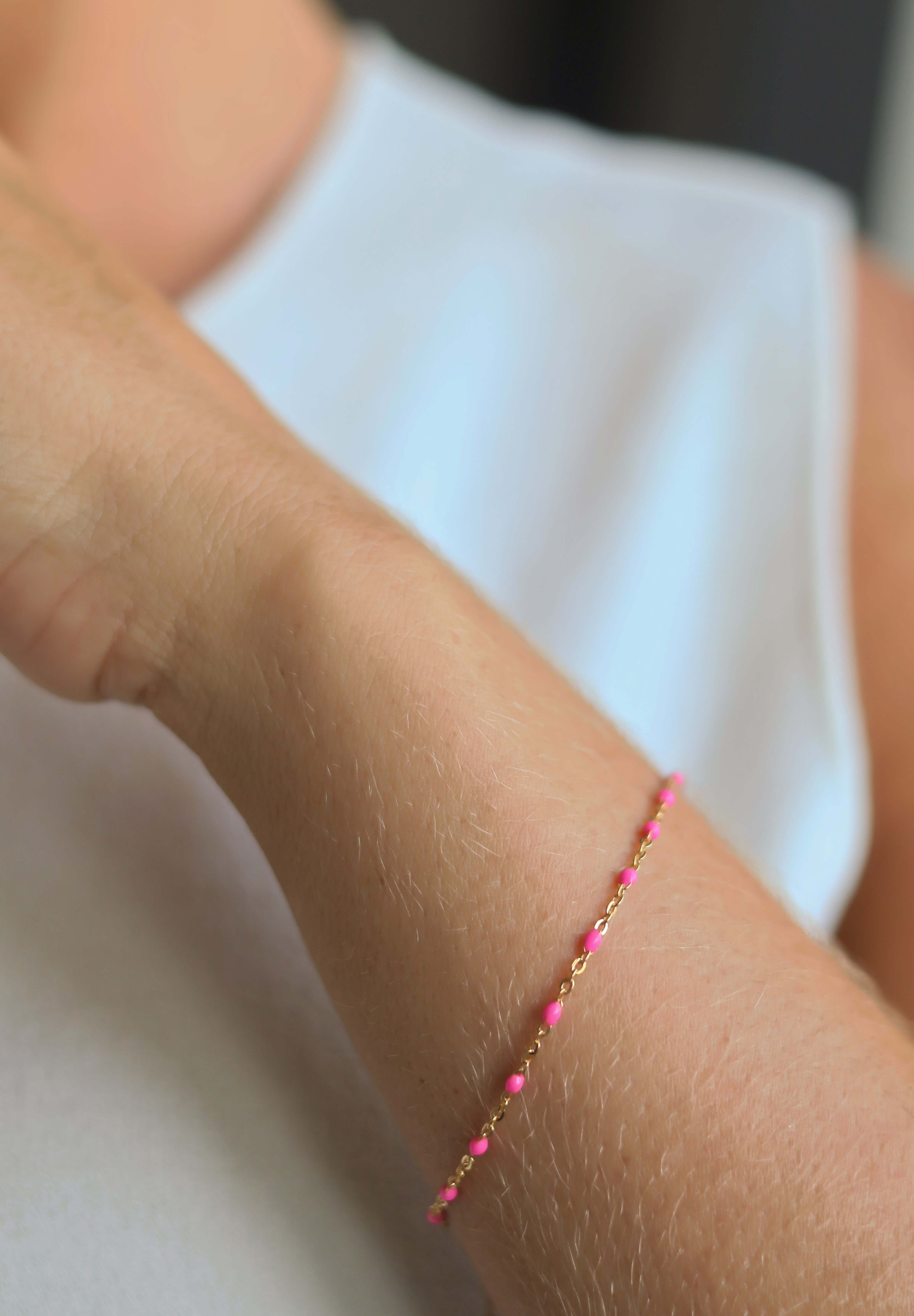 14k gold-filled pink beaded bracelet worn on a woman's wrist, showcasing blush pink details and elegant design.
