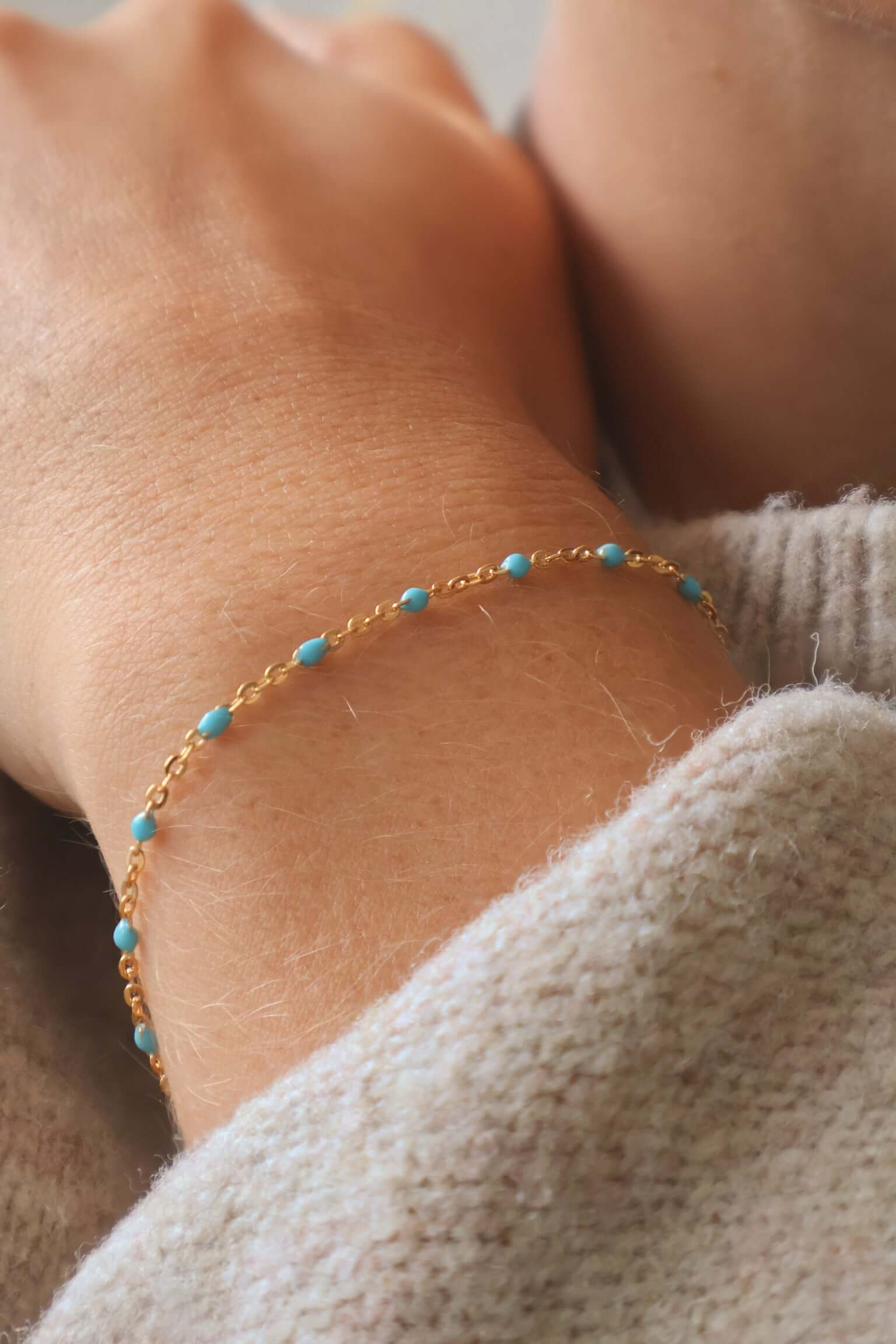 Close-up of a 14k Gold Turquoise Beaded Bracelet worn on a wrist, showcasing its delicate design and ocean-inspired color.
