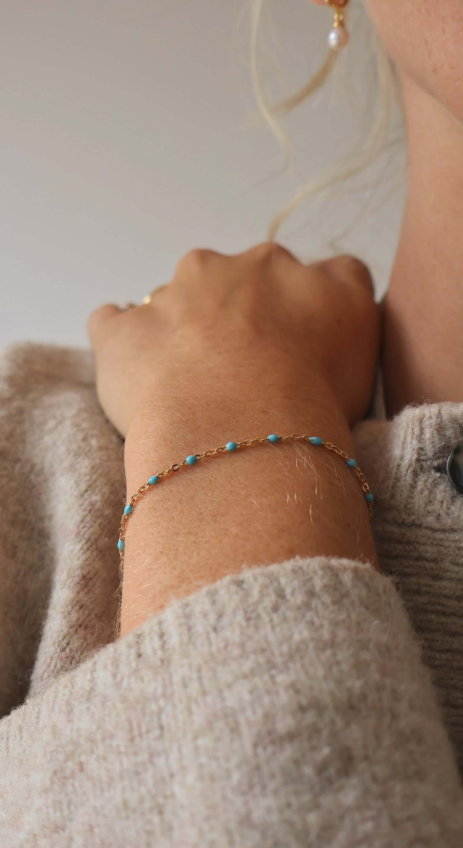 Close-up of a woman's wrist wearing a 14k Gold-Filled Turquoise Beaded Bracelet with delicate gold details.