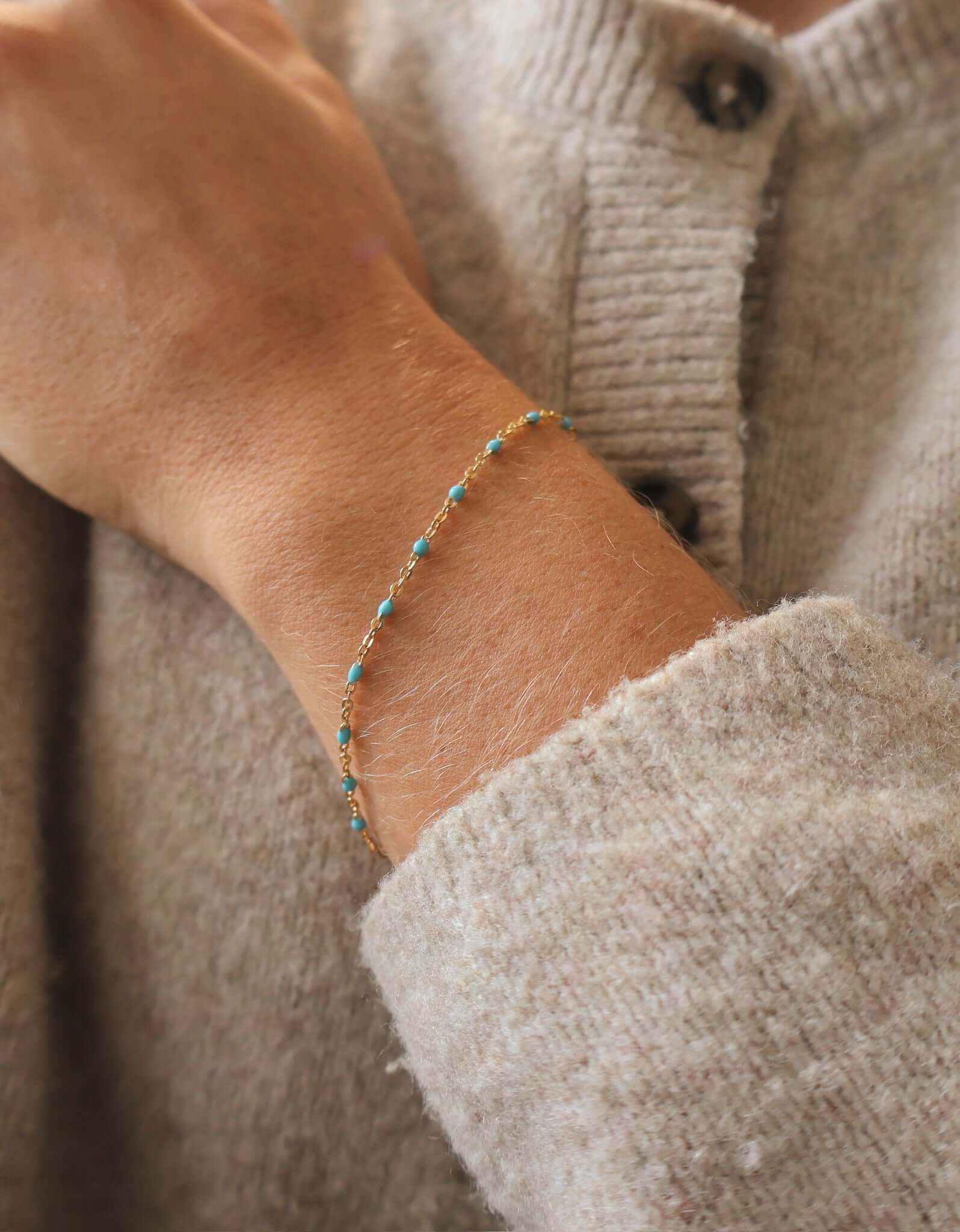 Close-up of a 14k Gold-Filled Turquoise Beaded bracelet on a wrist, showcasing ocean-inspired color.