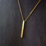 Gold personalised bar necklace showcasing elegance with engraved details, perfect for gifting special moments.