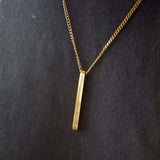Gold personalised bar necklace showcasing elegance with engraved details, perfect for gifting special moments.