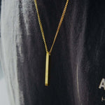 Gold personalised bar necklace elegantly displayed on a person, showcasing its beautiful design.