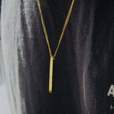 Gold personalised bar necklace elegantly displayed on a person, showcasing its beautiful design.