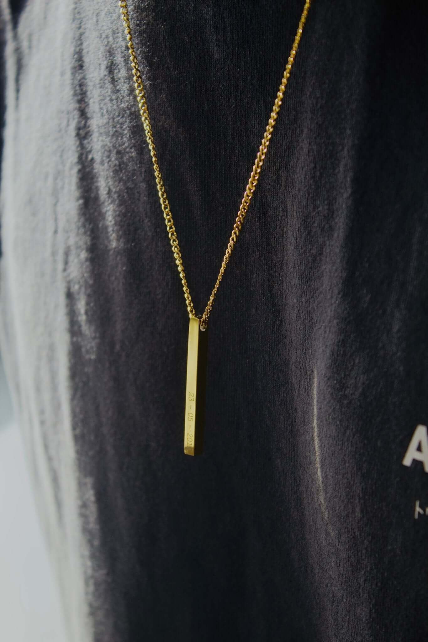 Gold personalised bar necklace elegantly displayed on a person, showcasing its beautiful design.