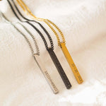 Variety of personalised bar necklaces in gold, silver, and black, showcasing engraved names and dates