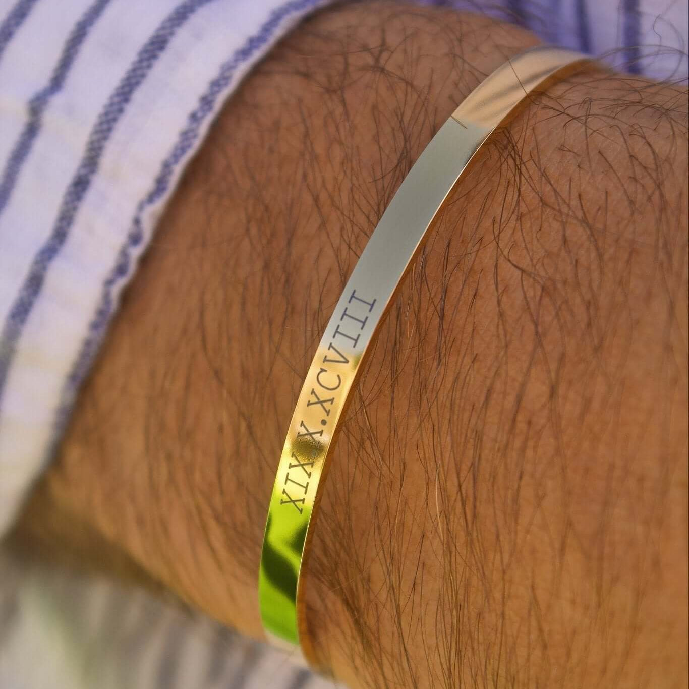 Personalised gold bracelet with engraved date, symbolizing cherished memories and special occasions.