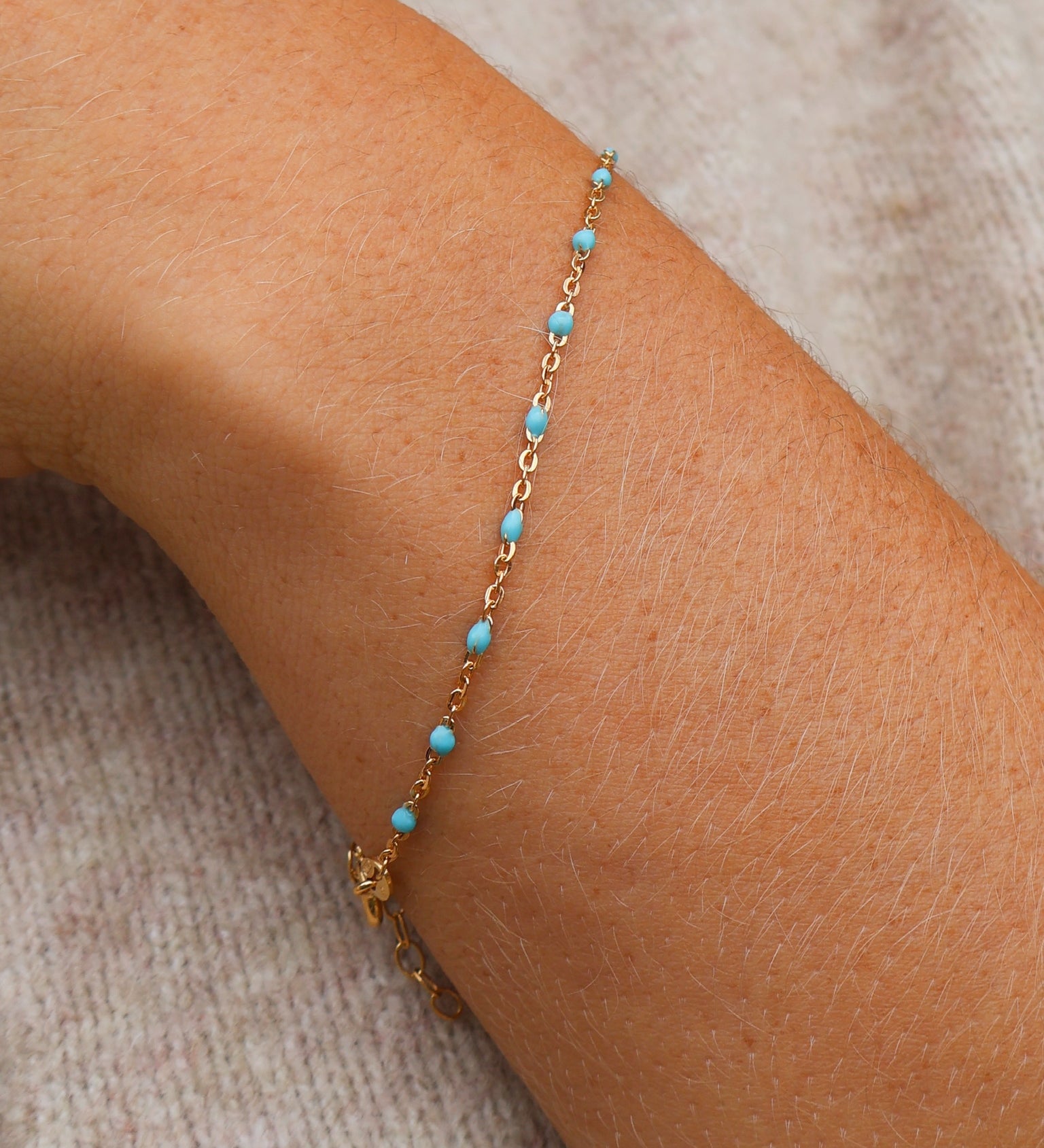 14k Gold Turquoise Beaded Bracelet on a wrist, showcasing ocean-inspired color and adjustable length.