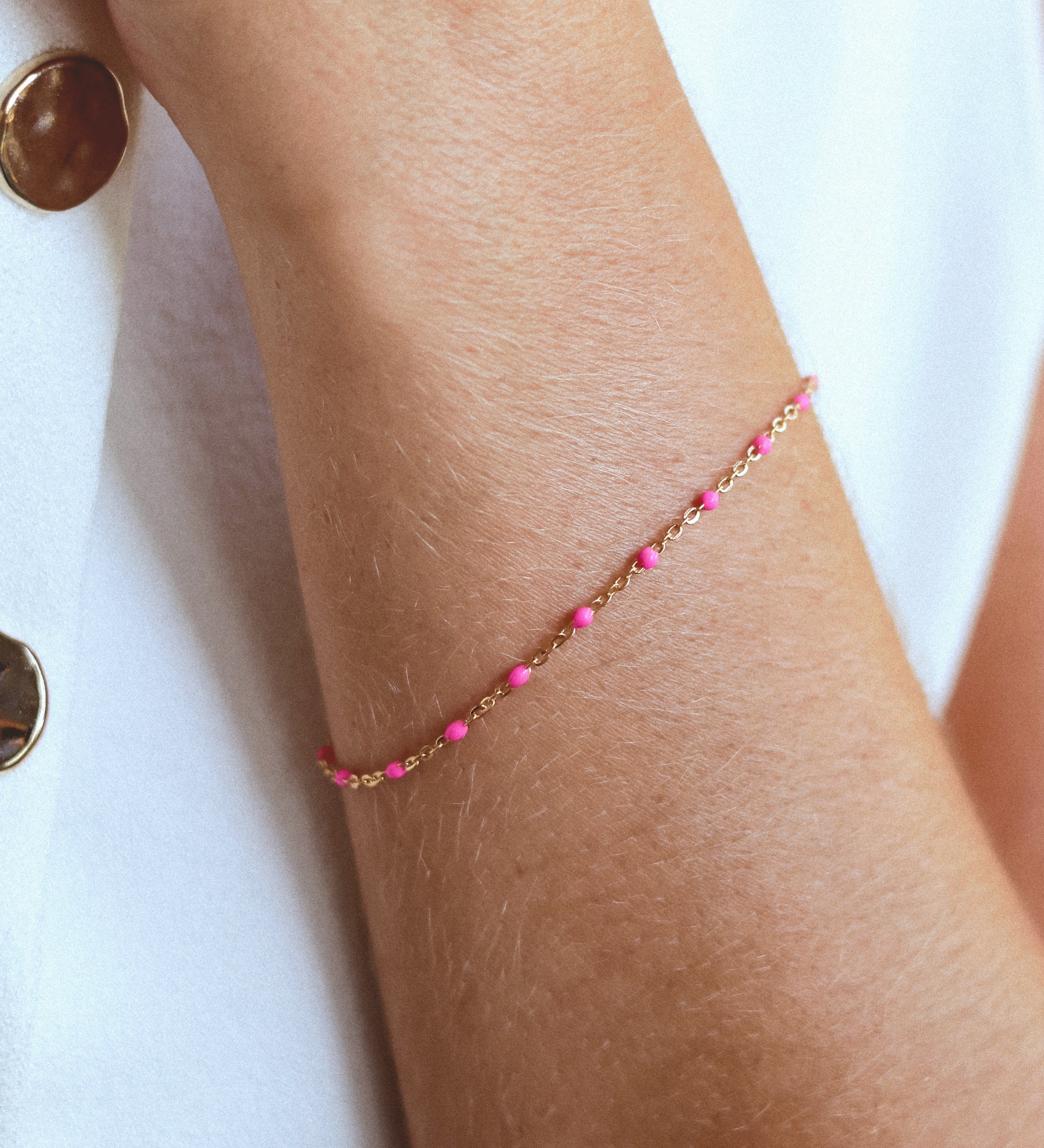 14k Gold-Filled Pink Beaded Bracelet on a wrist, showcasing blush pink beads on a delicate gold chain for a feminine touch.