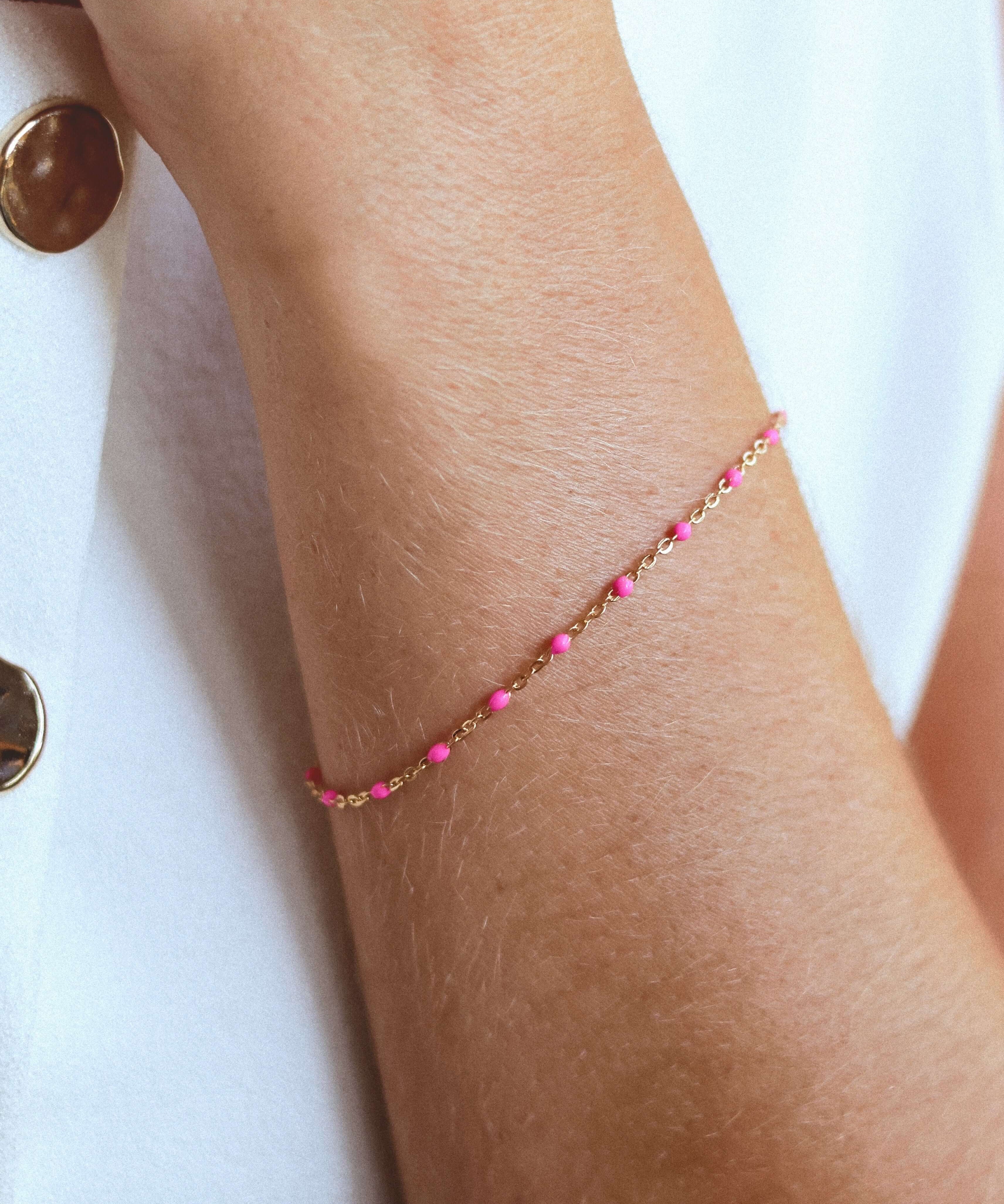 14k Gold-Filled Pink Beaded Bracelet on a wrist, showcasing blush pink beads on a delicate gold chain for a feminine touch.
