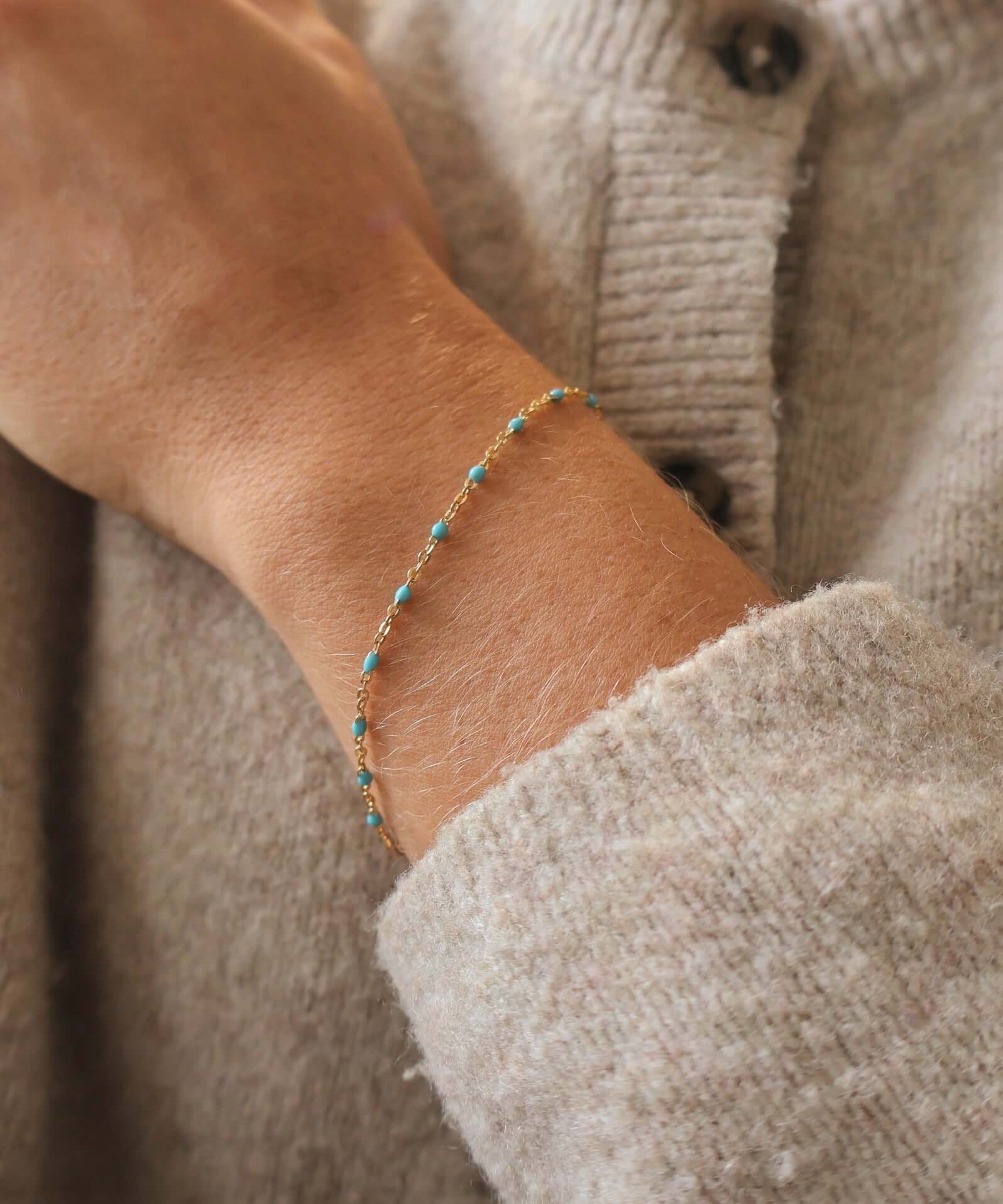 Close-up of a 14k Gold-Filled Turquoise Beaded bracelet on a wrist, showcasing ocean-inspired color.