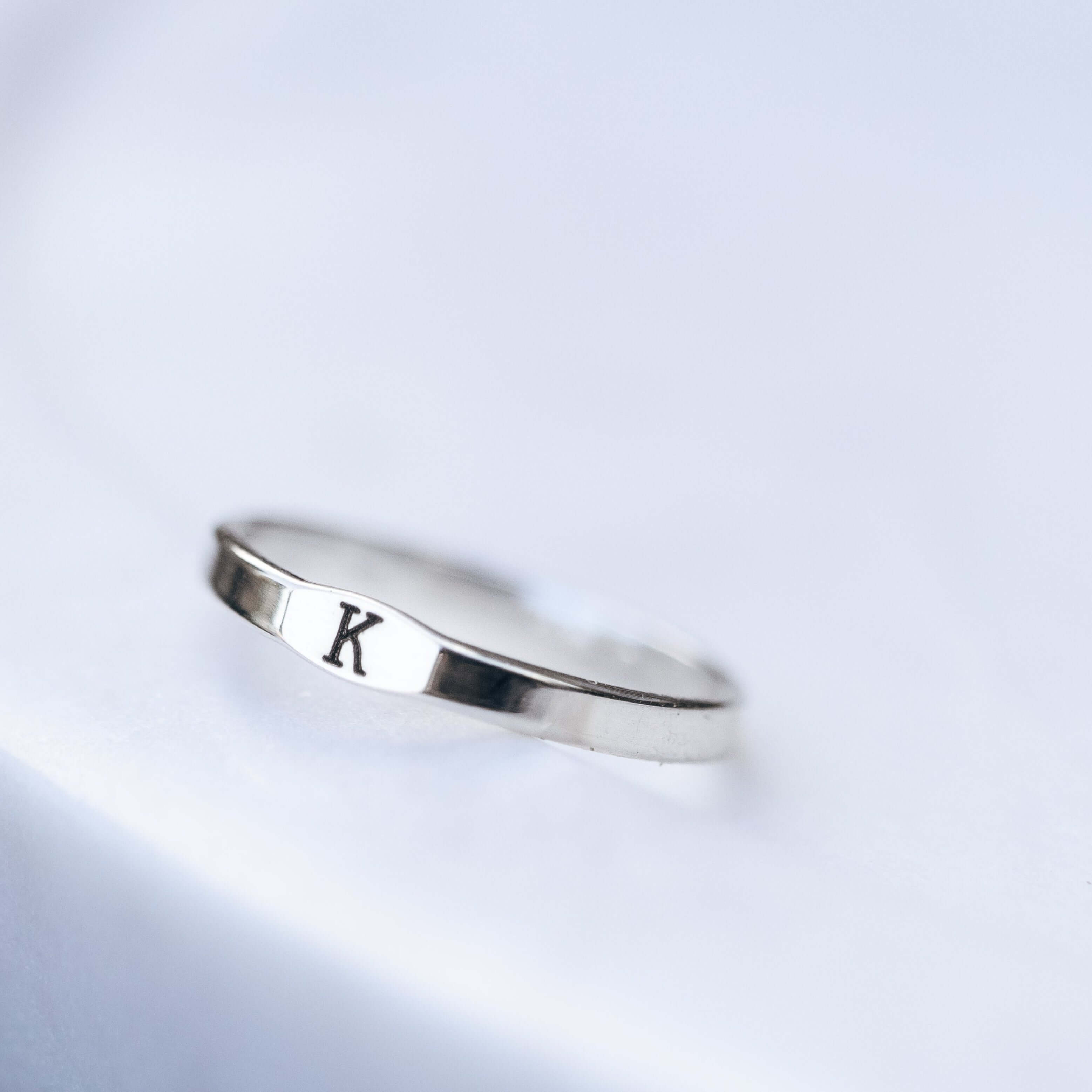 Sterling Silver with letter 'K' engraved on a light gray background