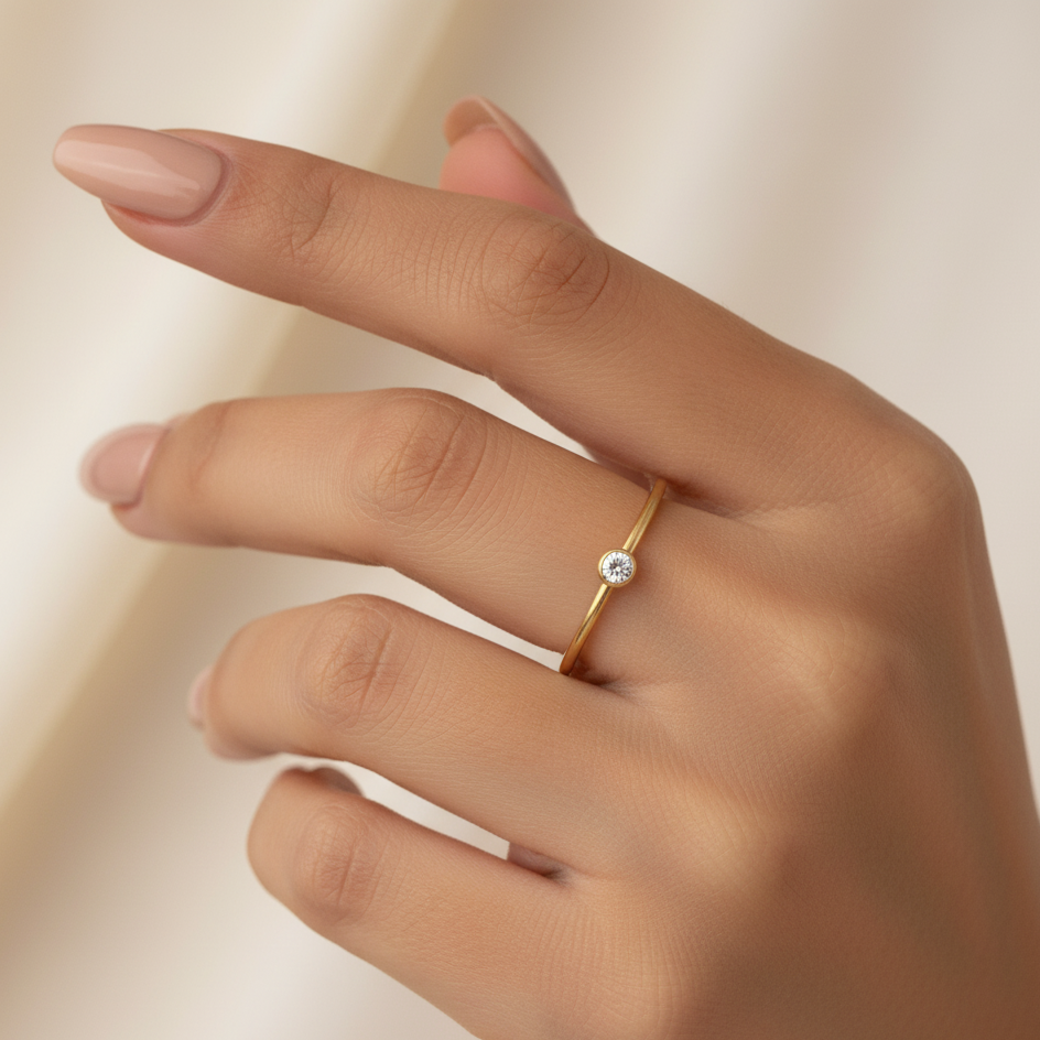 Close up of womans hand wearing gold CZ ring