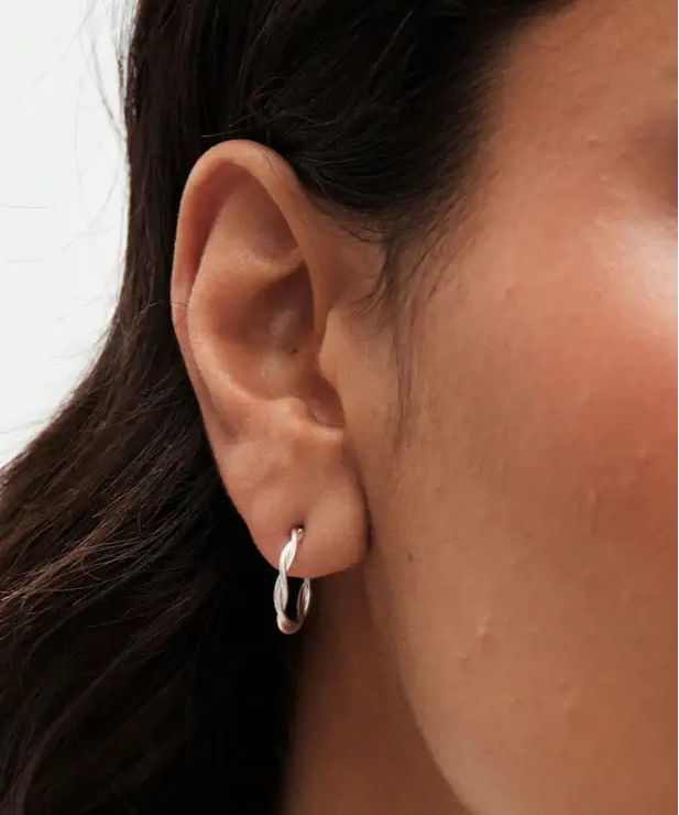 Close-up of a model wearing 20mm Sterling Silver Twisted Rope Hoop Earrings, showcasing elegance and style.